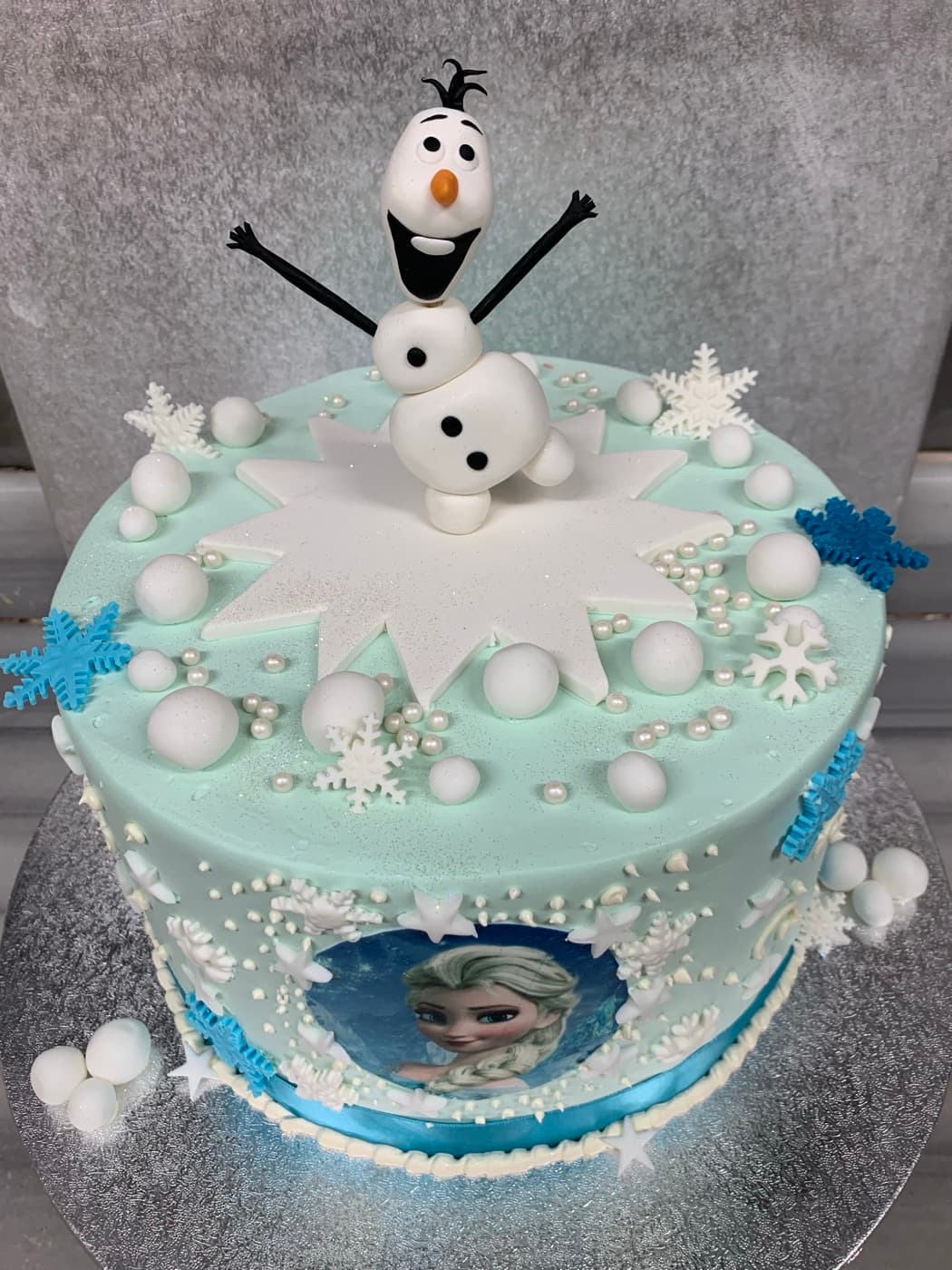 Frozen-themed birthday cake with Elsa and Olaf figures