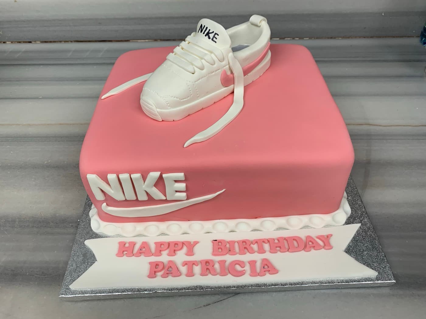 Birthday cake topped with a sculpted sneaker