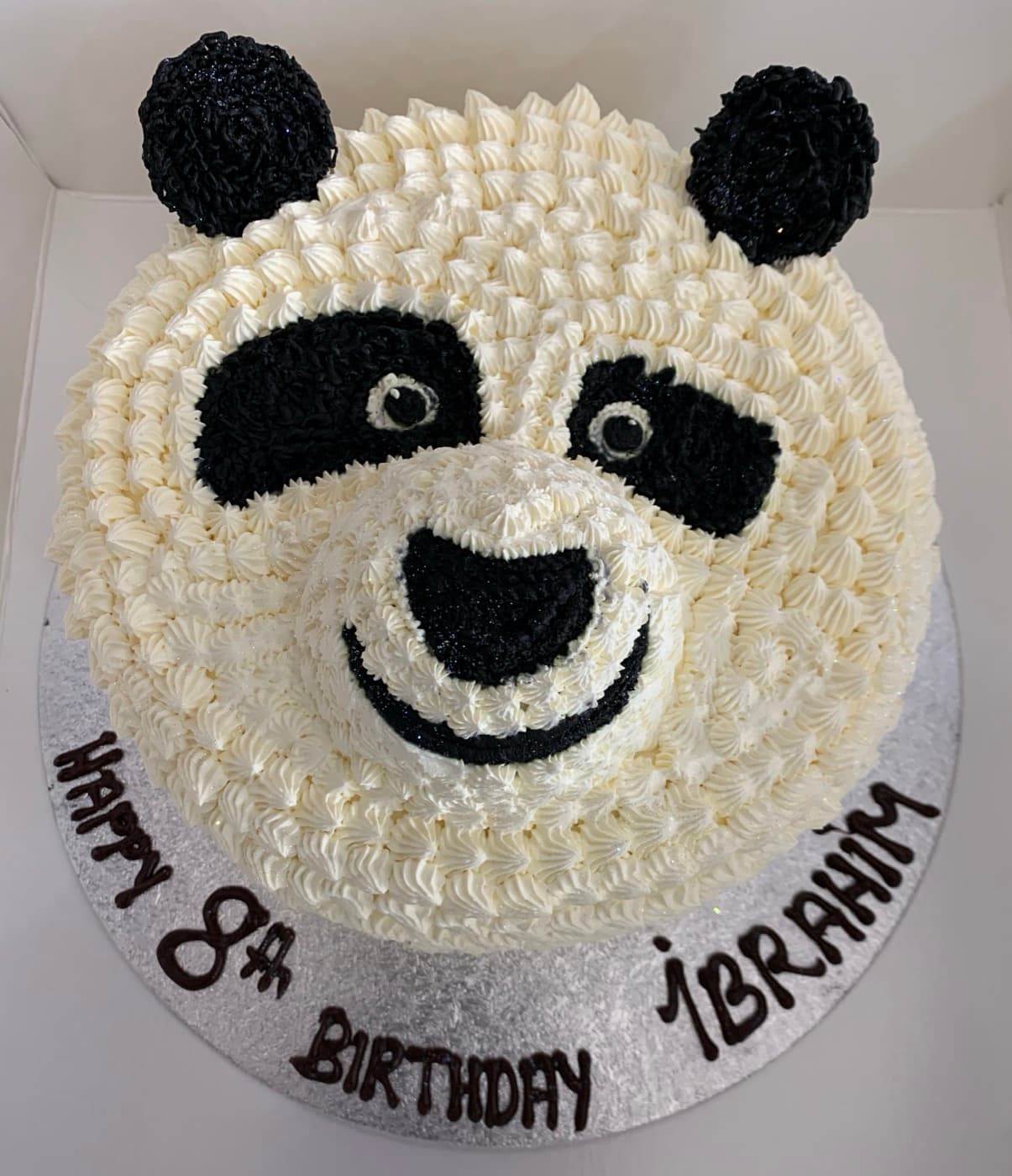 Buttercream cake decorated as a panda face